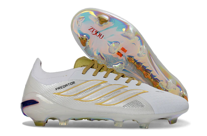 Adidas Predator x Elite FG white and gold soccer cleats with textured upper and studs for firm ground play.