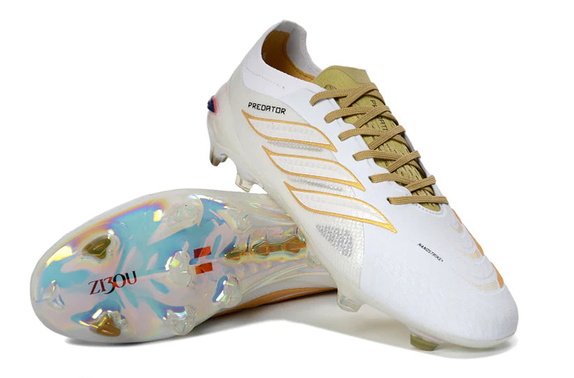 Adidas Predator x Elite FG white and gold soccer cleats with textured upper and studded sole for optimal grip on the field.