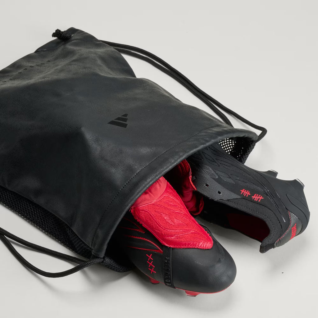 adidas Predator Elite L-TECH fold-over tongue soccer cleats in black and red for firm ground play, featuring a sleek design and performance grip.