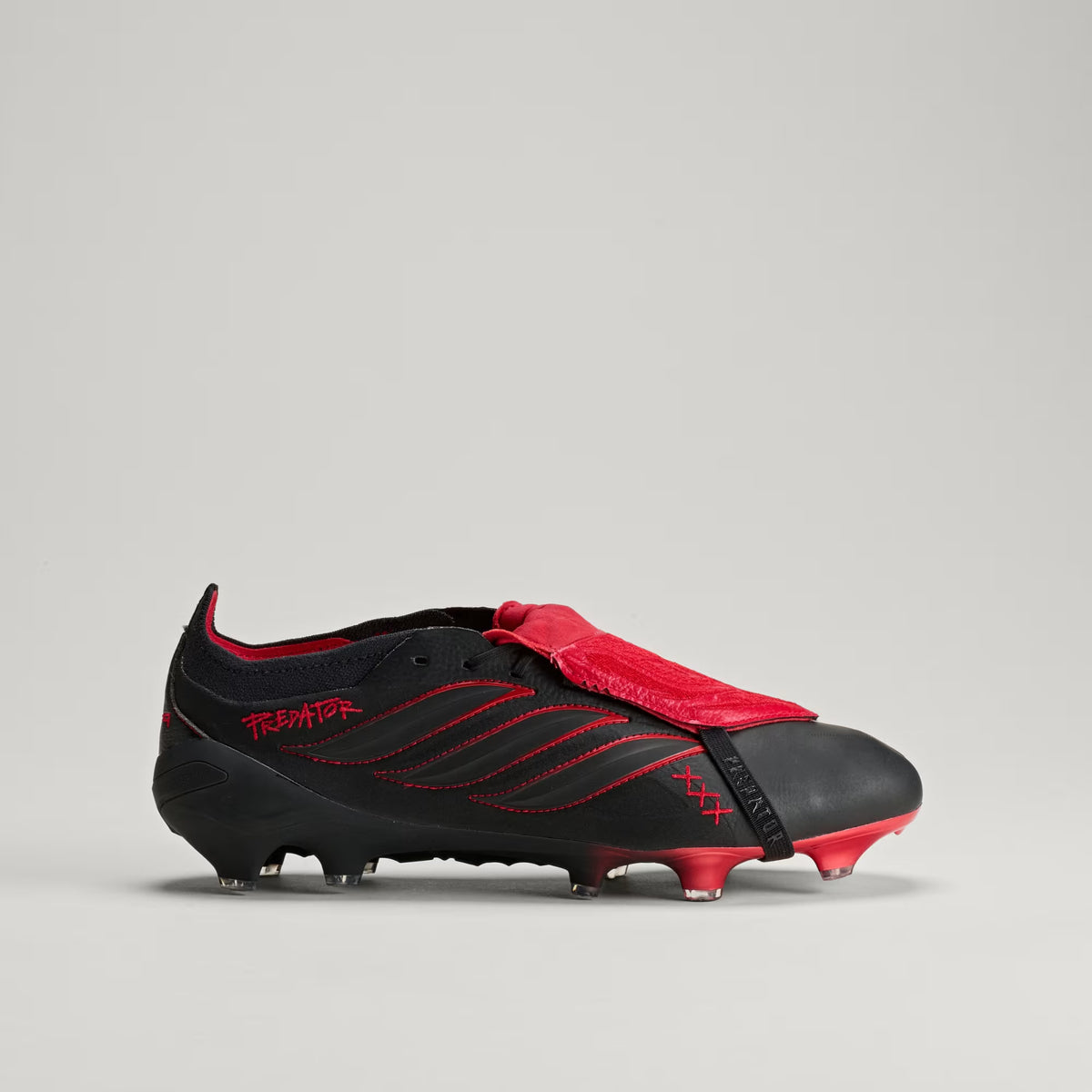 adidas Predator Elite L-TECH fold-over tongue soccer cleats in black and red for firm ground play, designed for precision and control