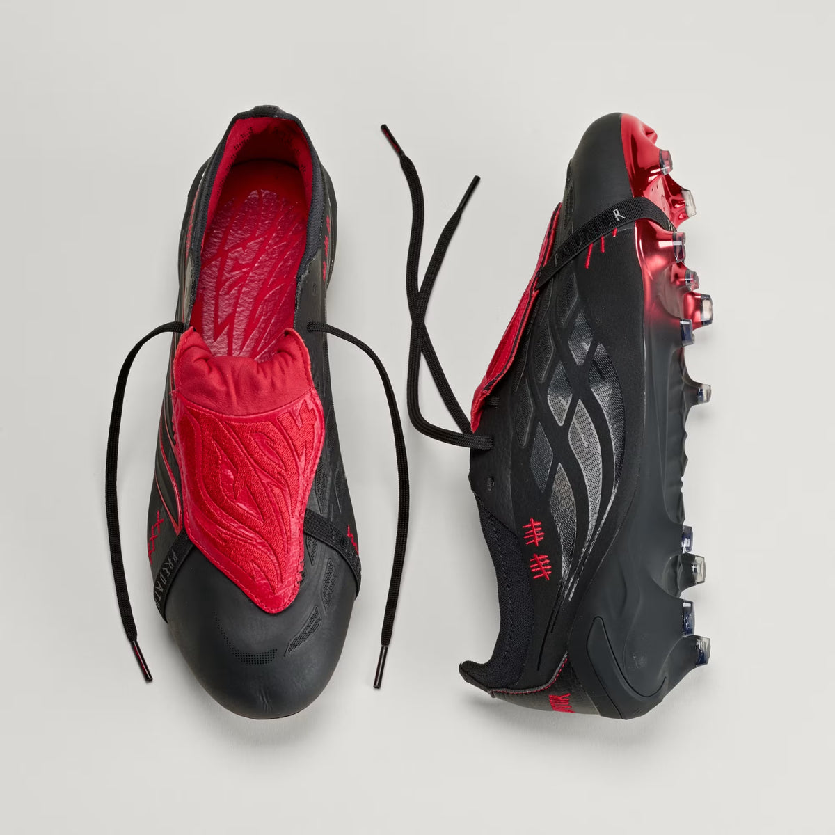 adidas Predator Elite L-TECH fold-over tongue soccer cleats in black and red for firm ground play
