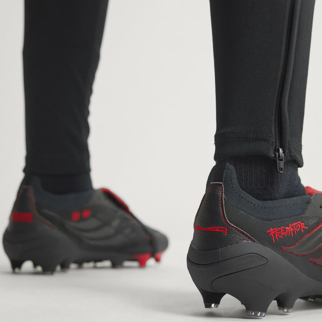 adidas Predator Elite L-TECH fold-over tongue soccer cleats in black and red, designed for firm ground play